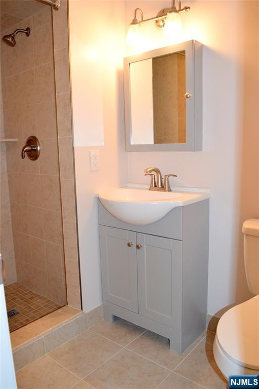533 Roff Avenue Palisades Park, NJ 07650 - Photo 8 of 16 a bathroom with a sink a toilet a mirror and shower