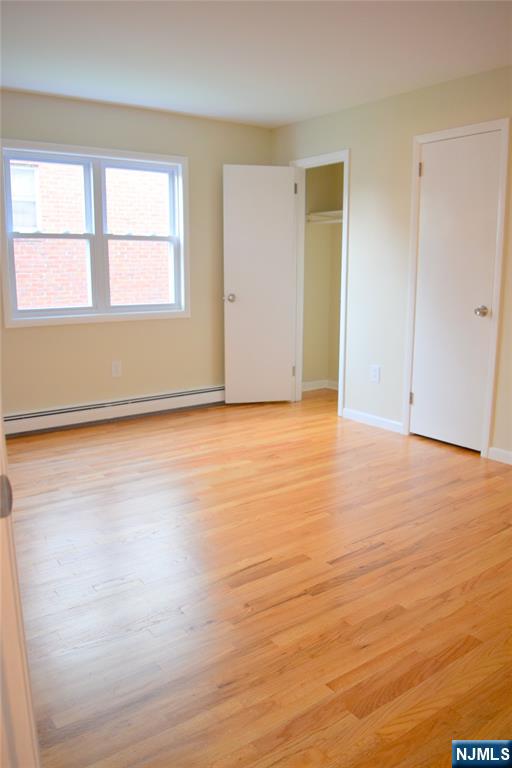 533 Roff Avenue Palisades Park, NJ 07650 - Photo 10 of 16 an empty room with wooden floor and windows