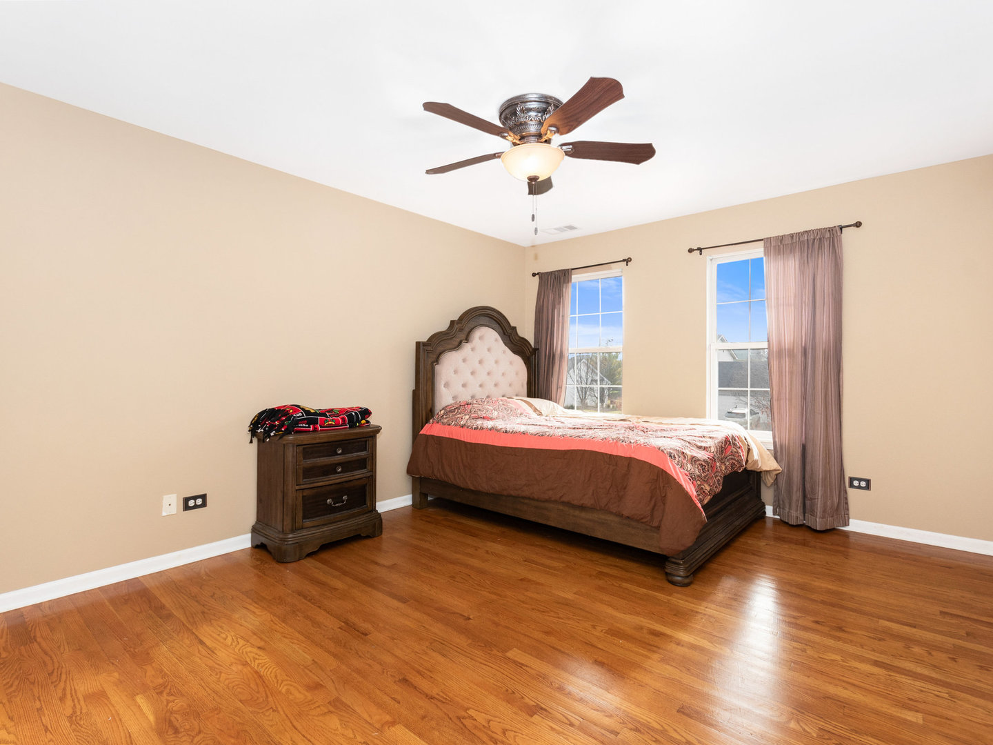 5519 Stonybrook Drive Plainfield, IL 60586 - Photo 11 of 27 a bedroom with a bed and a chandelier