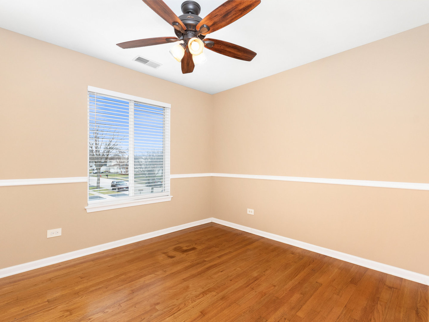 5519 Stonybrook Drive Plainfield, IL 60586 - Photo 15 of 27 an empty room with a window and a fan
