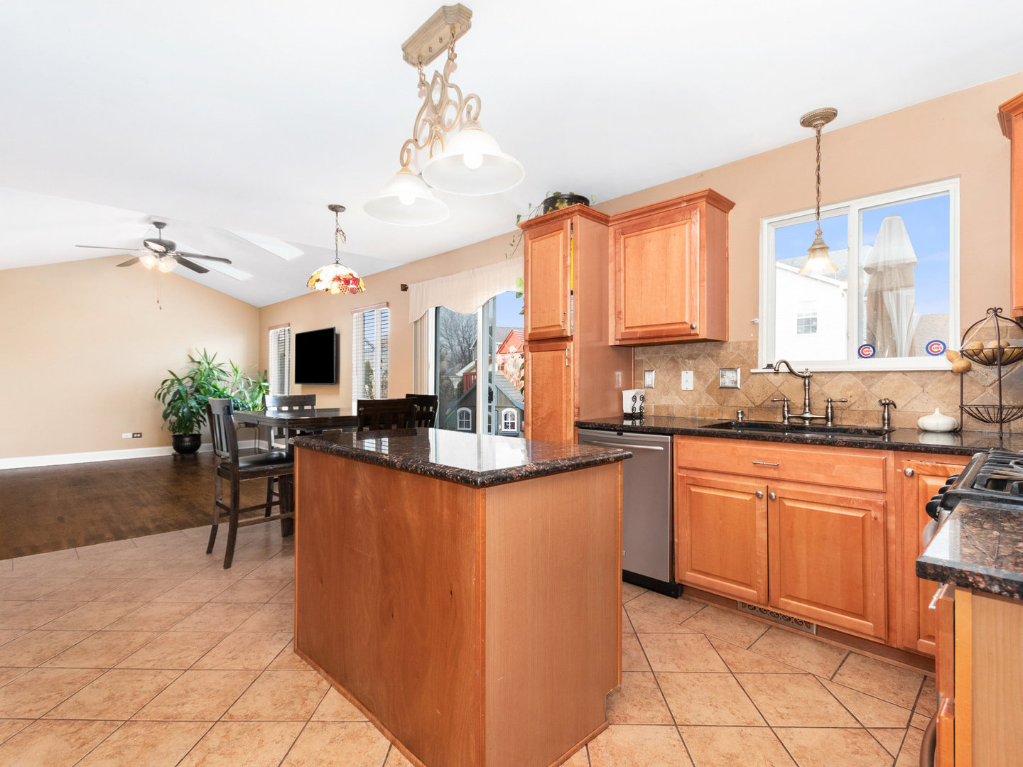 5519 Stonybrook Drive Plainfield, IL 60586 - Photo 7 of 27 a kitchen with stainless steel appliances kitchen island granite countertop a sink and cabinets