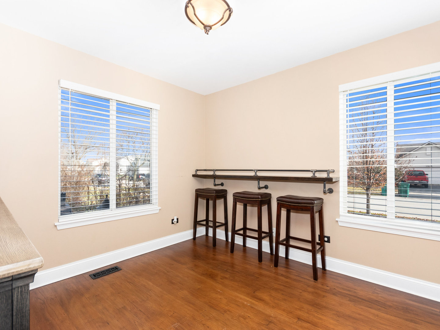 5519 Stonybrook Drive Plainfield, IL 60586 - Photo 9 of 27 a view of an empty room with wooden floor and a window
