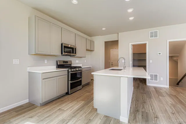 a kitchen with a stove a sink and a microwave