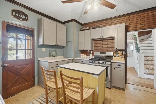 a kitchen with a stove a sink and a refrigerator