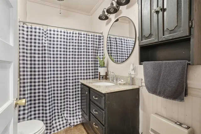 a bathroom with a sink a toilet and mirror