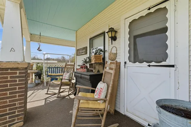 a view of a chairs and table in the balcony