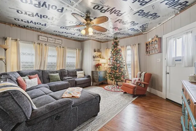 a living room with furniture and a chandelier