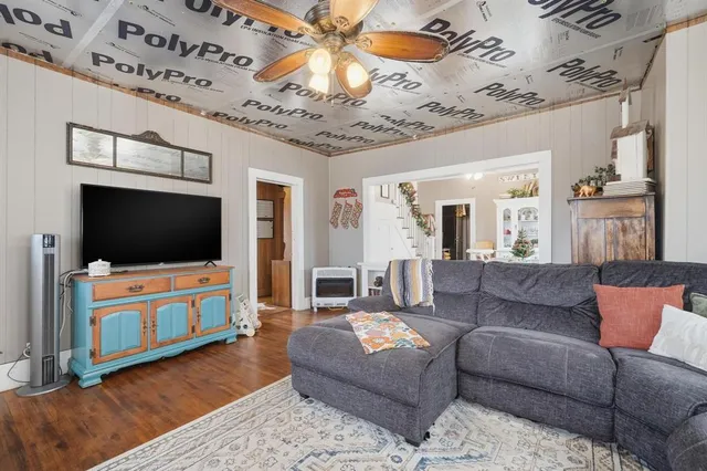 a living room with furniture and a flat screen tv