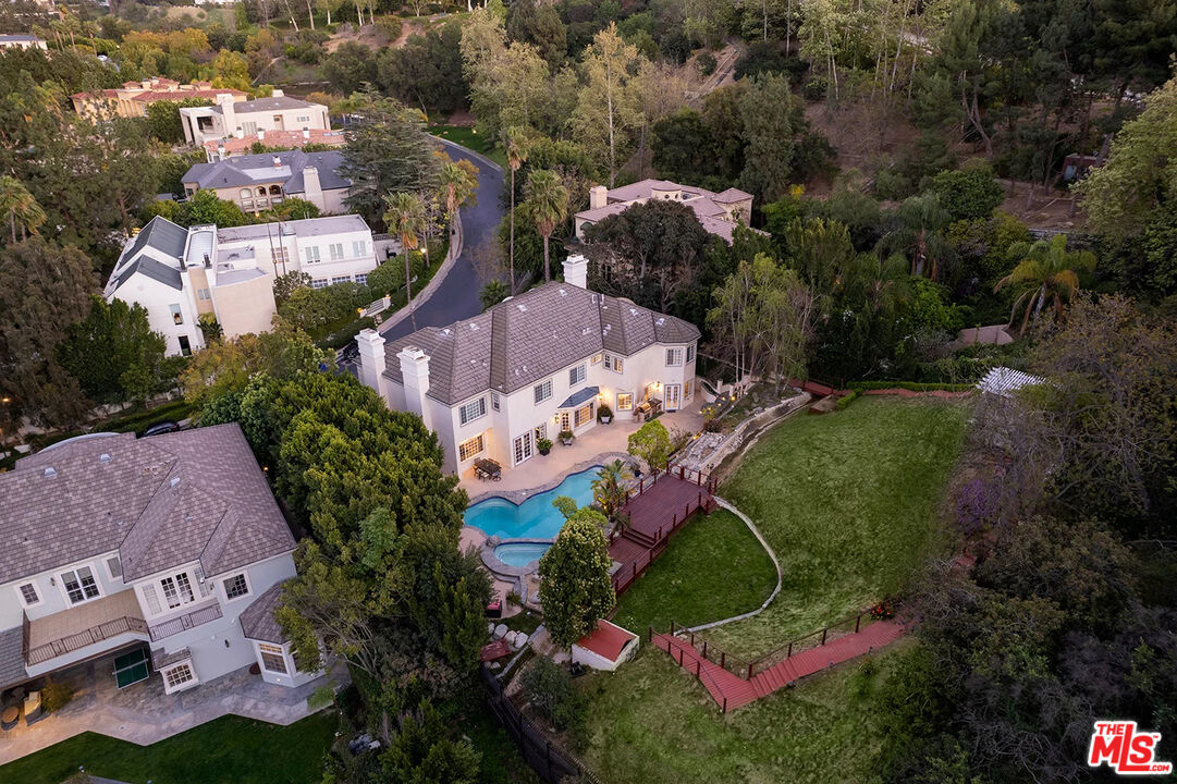 an aerial view of a house with a yard and lake view