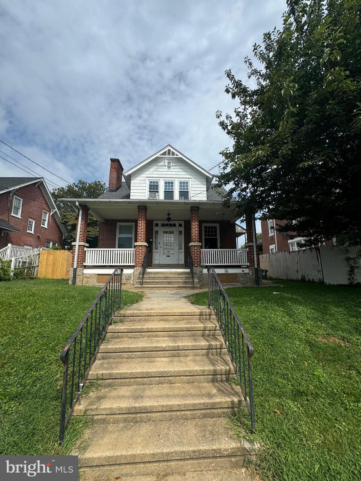 885 Manor Street Lancaster, PA 17603 - Photo 4 of 13 a front view of a house with a garden and trees