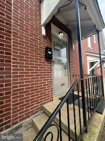 a view of a brick building with a glass door