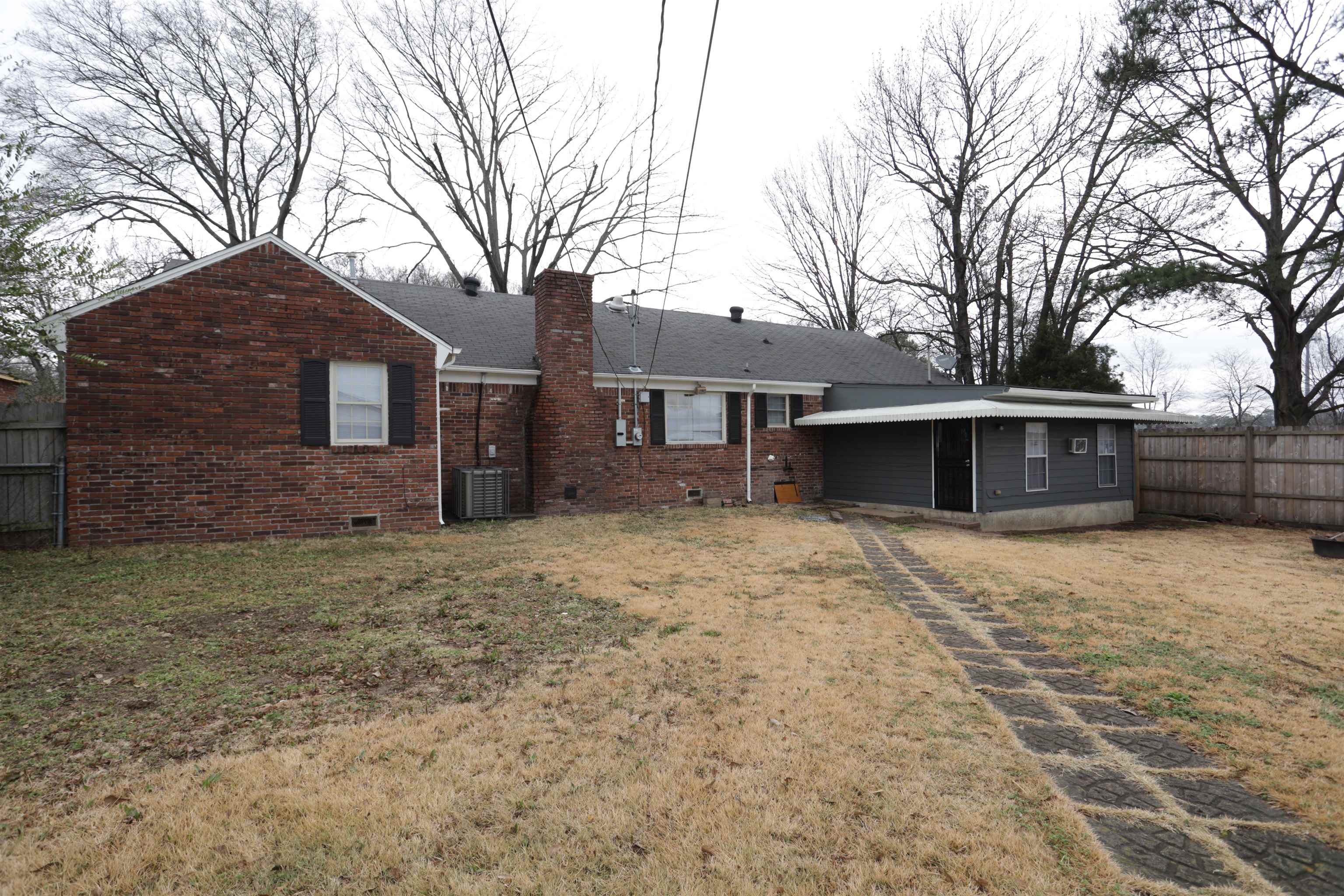 3272 Powers Road Memphis, TN 38128 - Photo 7 of 23 a front view of a house with a yard and garage