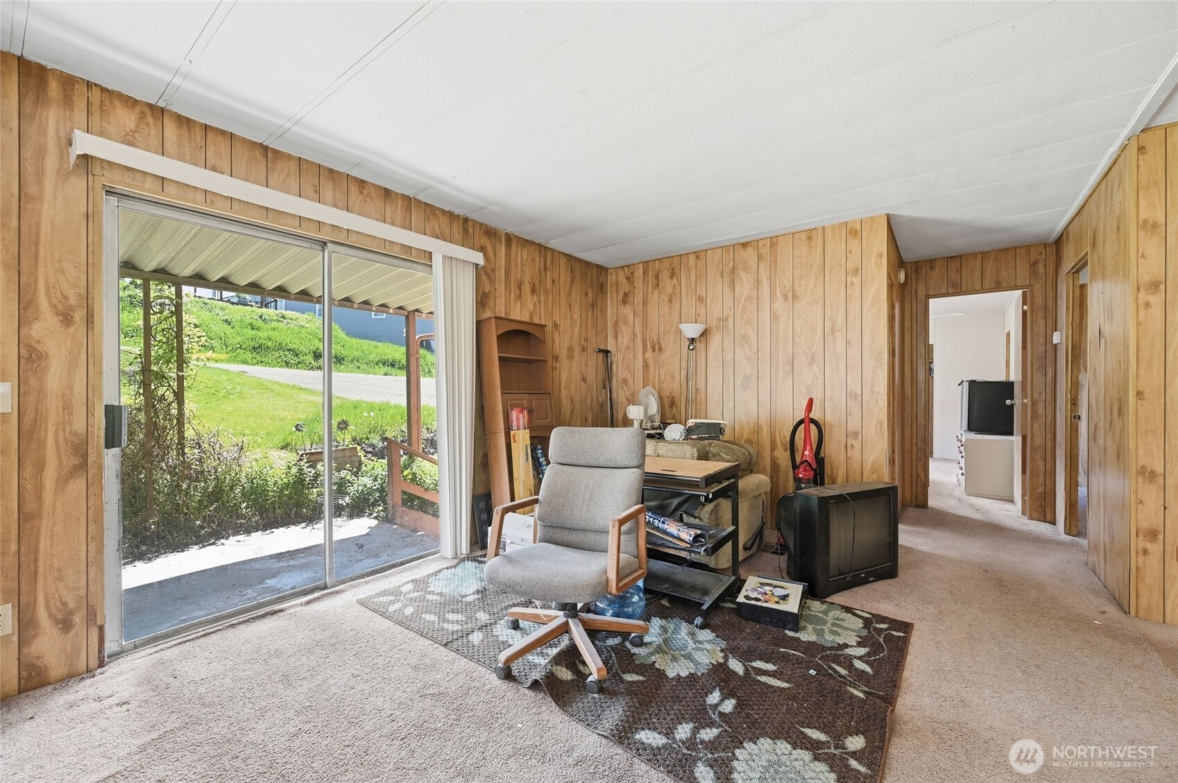 32711 Commission Avenue Black Diamond, WA 98010 - Photo 11 of 34 a living room with furniture and a floor to ceiling window