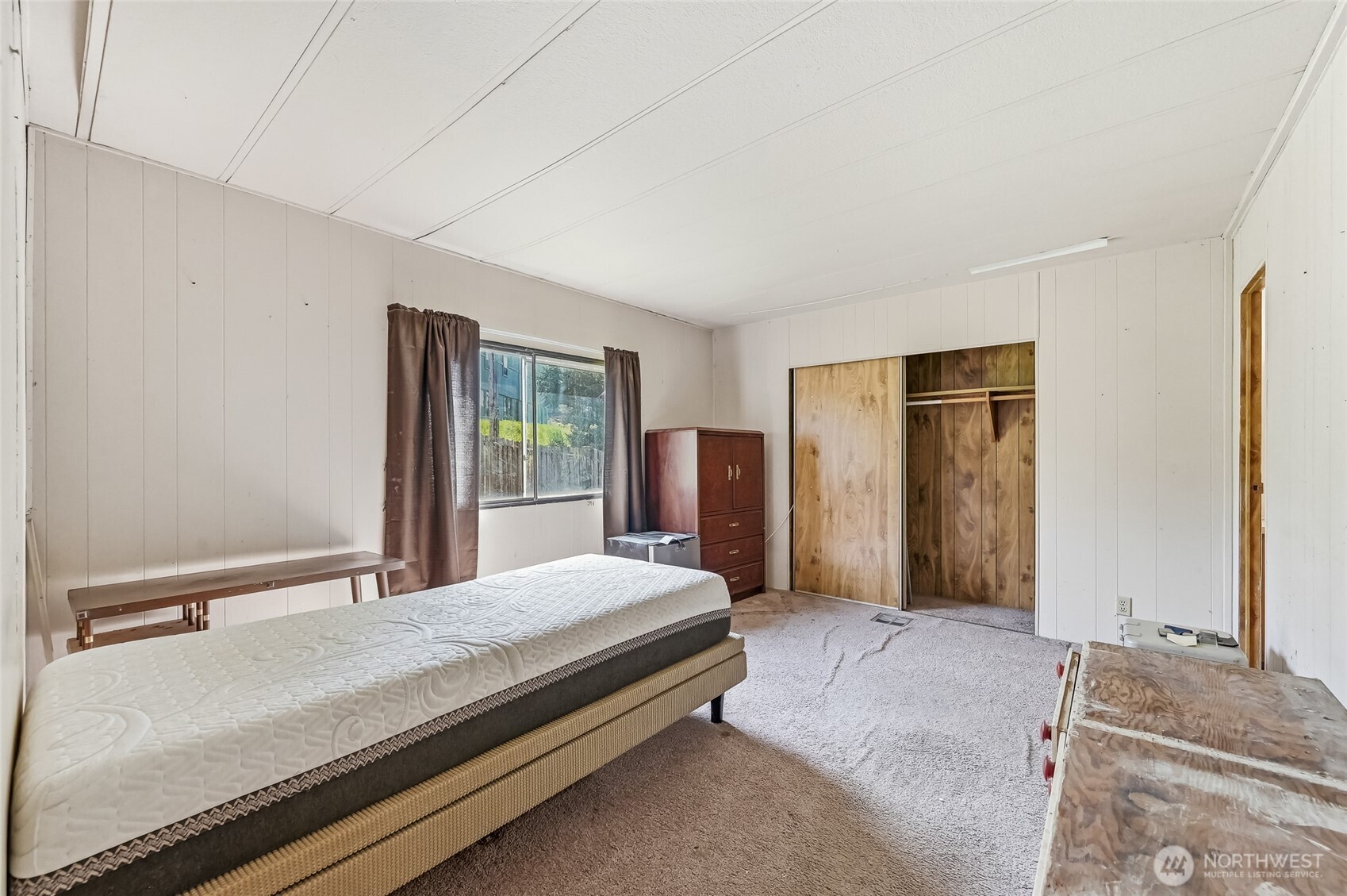 32711 Commission Avenue Black Diamond, WA 98010 - Photo 16 of 34 a bedroom with a large bed and a dresser