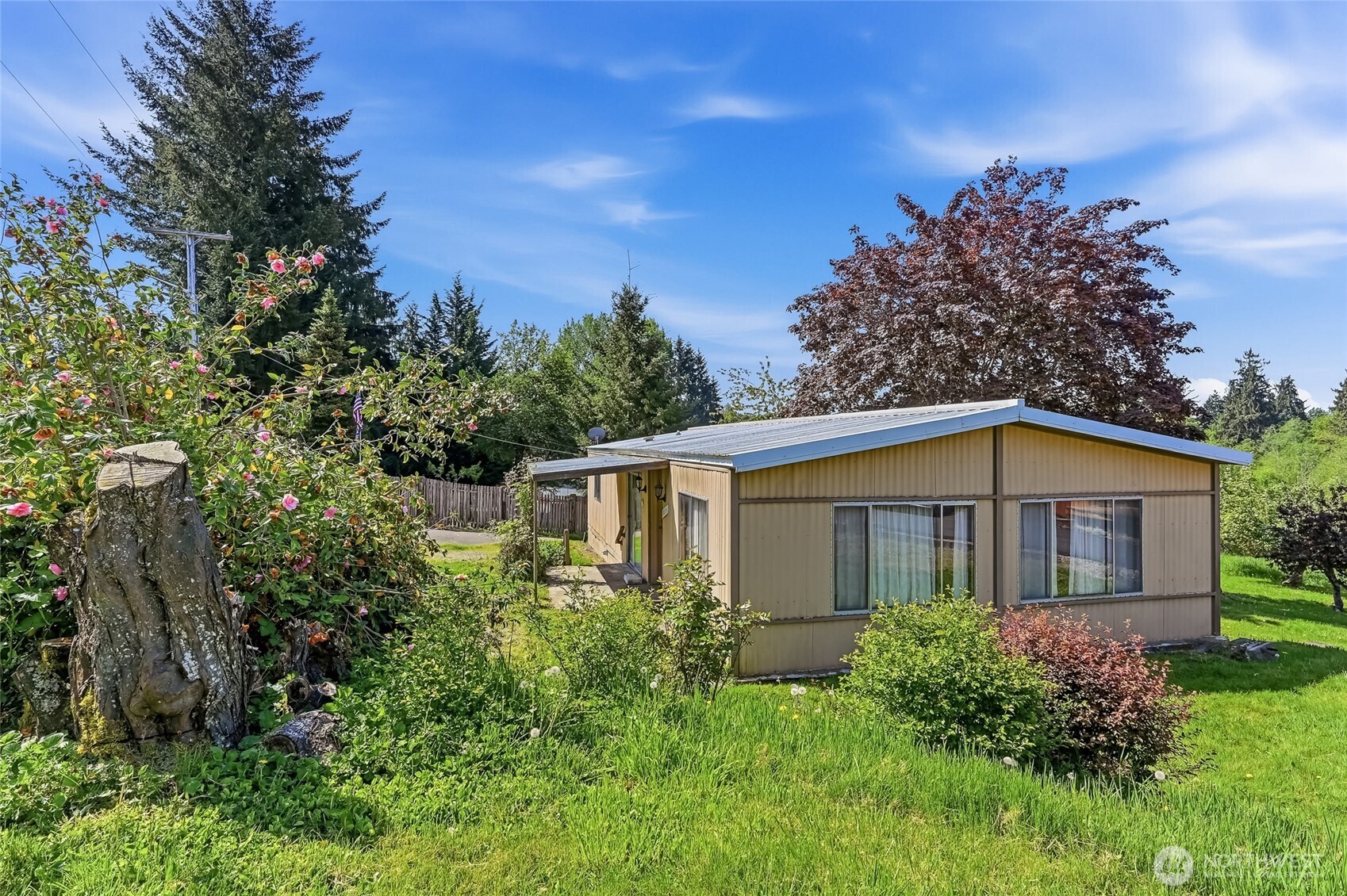 32711 Commission Avenue Black Diamond, WA 98010 - Photo 22 of 34 a view of a yard in front of a house with a large tree