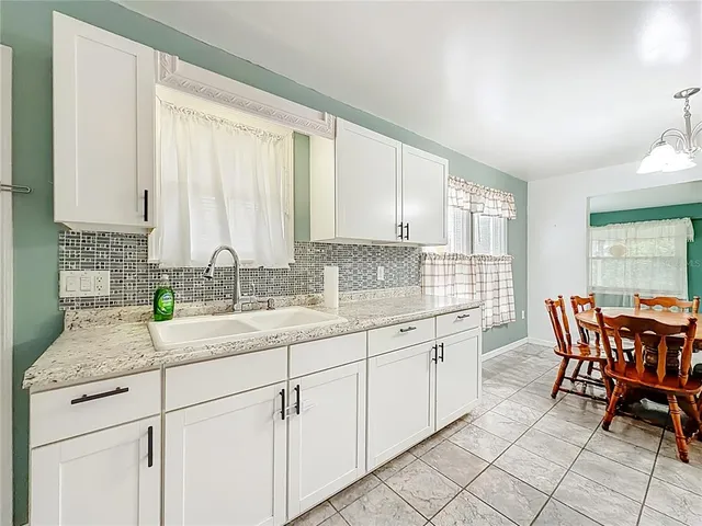 a kitchen with sink and cabinets