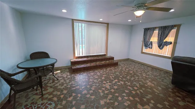 a kitchen with a refrigerator and a stove top oven