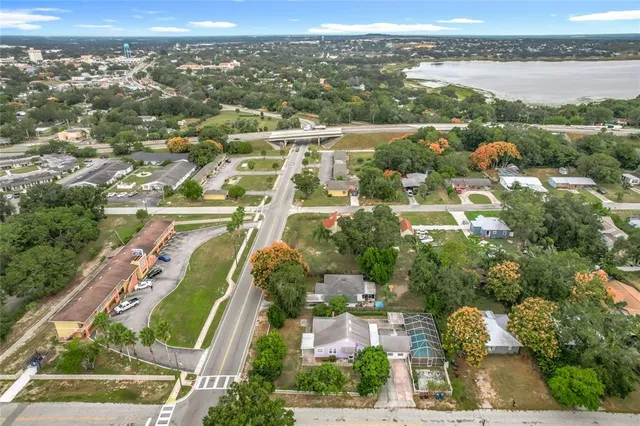 an aerial view of residential houses with outdoor space and river