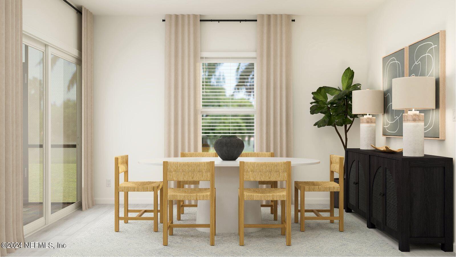 745 Lake Sinclair Street St. Augustine, FL 32084 - Photo 4 of 19 a view of a dining room with furniture and a potted plant
