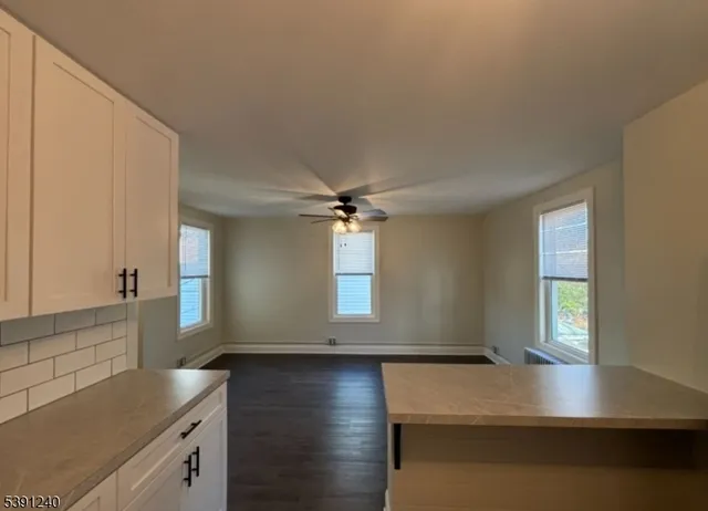 a kitchen with kitchen island a counter top space and a sink