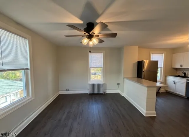 a view of livingroom with furniture wooden floor and a window