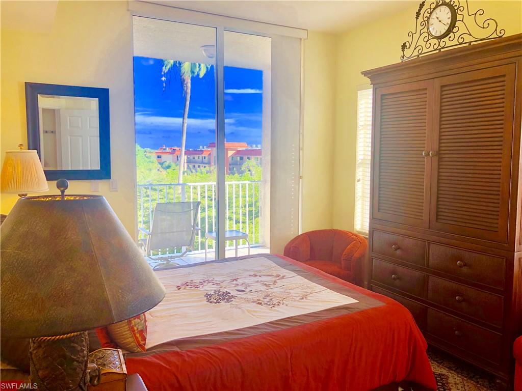 451 Bayfront Place, Unit 5311 Naples, FL 34102 - Photo 34 of 38 a bedroom with a bed a dresser and a window