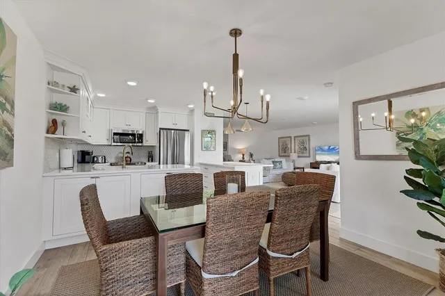 a bedroom with a bed a mirror and a large window