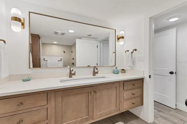 a bedroom with two beds and a night stand