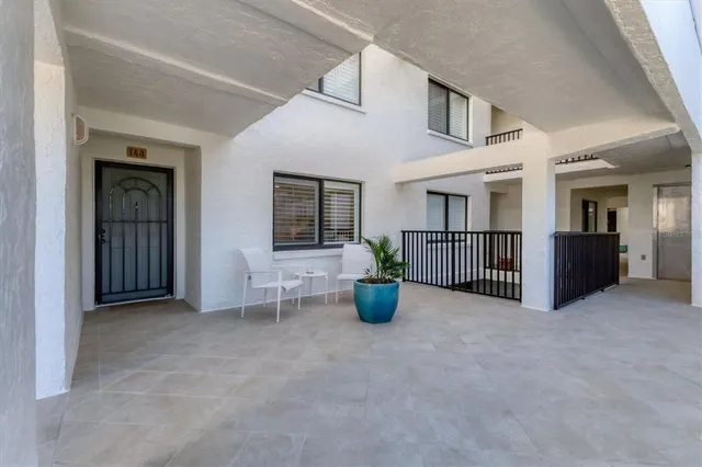 a view of a hallway with wooden floor and a bathroom