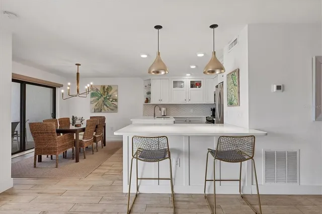 a kitchen with stainless steel appliances granite countertop a refrigerator sink and stove