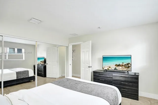 a bedroom with a bed and a couch