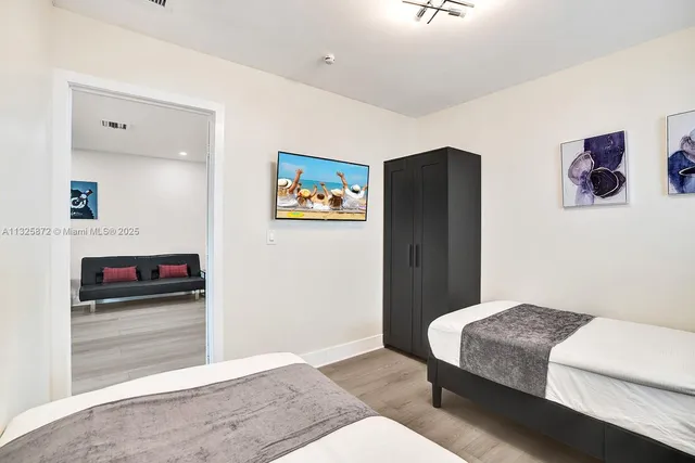 a spacious bedroom with a bed and a desk