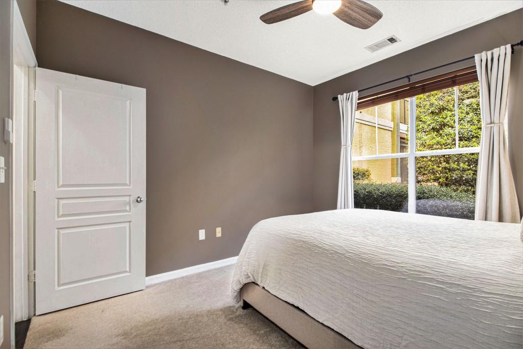 10 Perimeter Summit Boulevard, Unit 2112 Atlanta, GA 30319 - Photo 22 of 40 a bedroom with a large bed and a large window