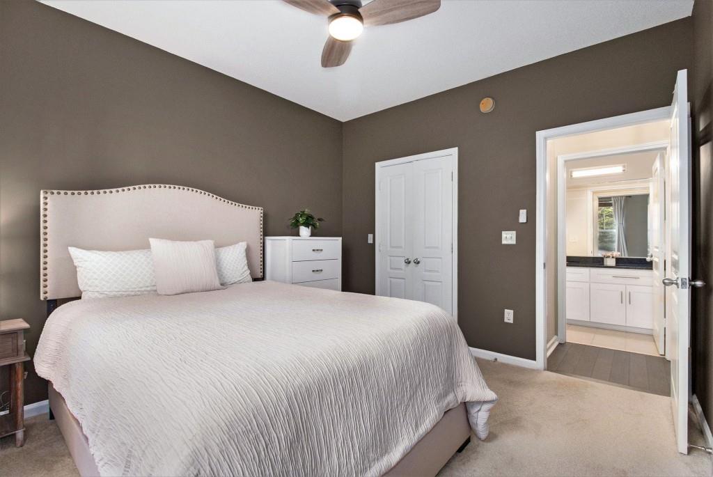 10 Perimeter Summit Boulevard, Unit 2112 Atlanta, GA 30319 - Photo 23 of 40 a bedroom with a large bed and a chandelier