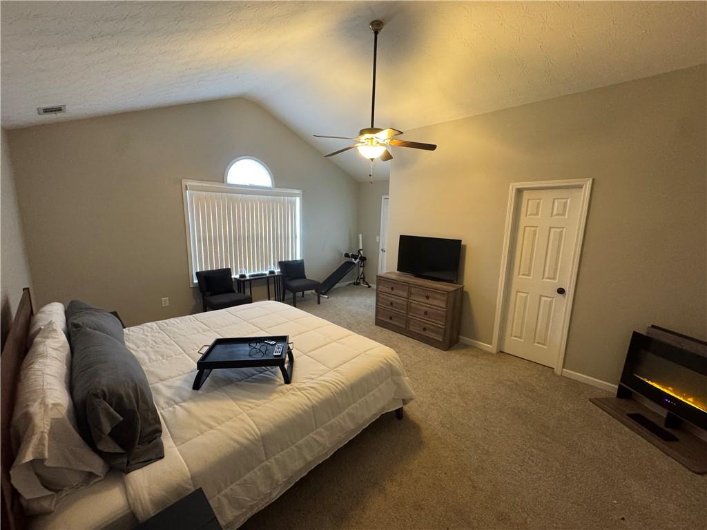 1922 Manhattan Parkway Decatur, GA 30035 - Photo 6 of 9 a bedroom with a bed a couch and a flat screen tv