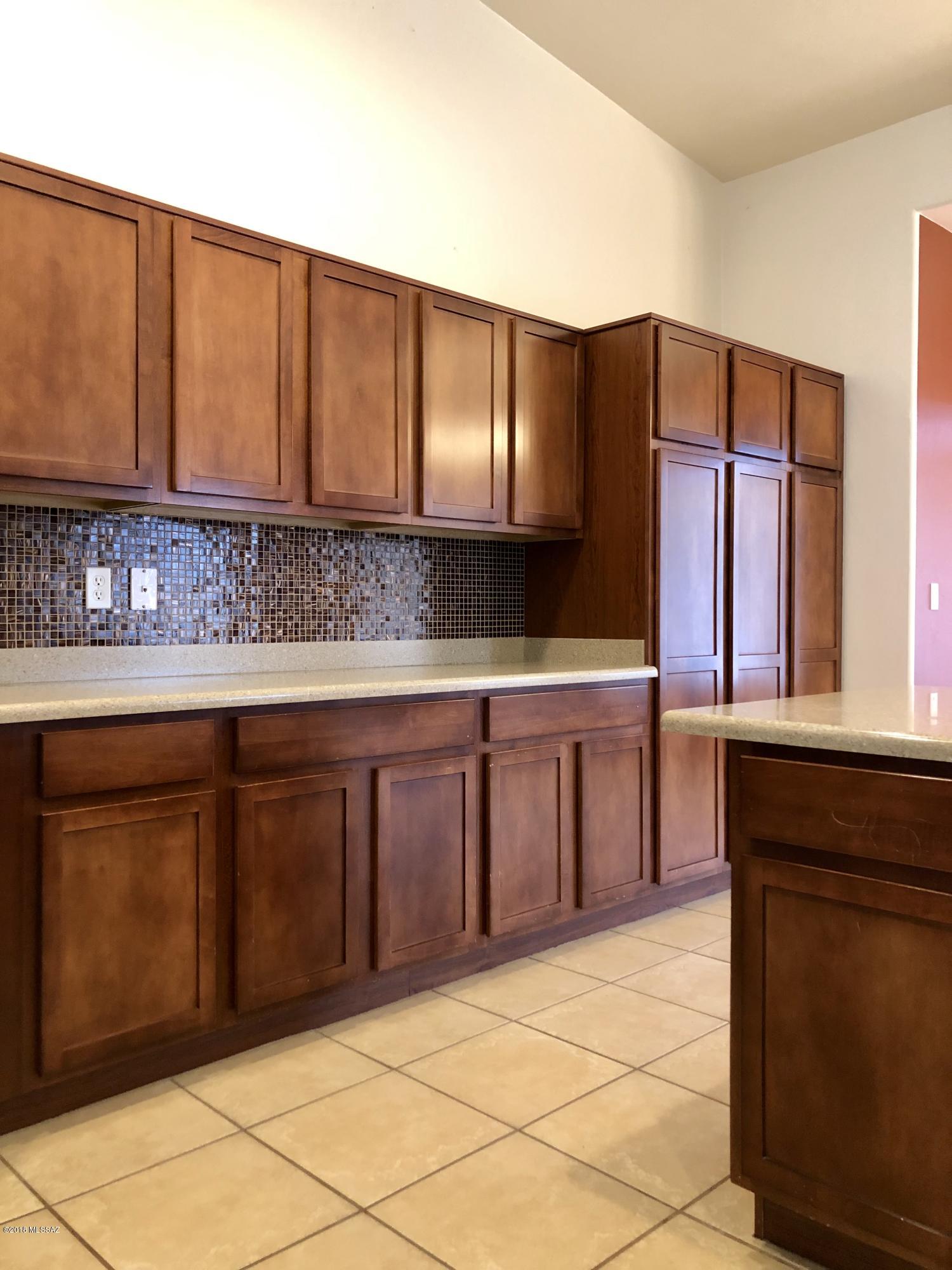 1435 Circulo Sombrero Rio Rico, AZ 85648 - Photo 13 of 40 a kitchen with stainless steel appliances granite countertop a stove a sink and a microwave