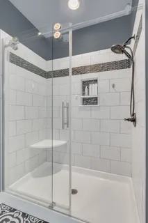 a bathroom with a shower and a sink