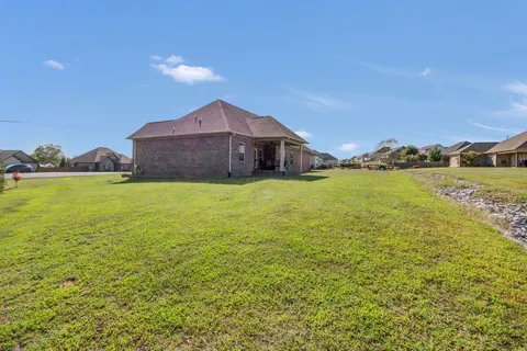 a view of a house with a yard and a large pool