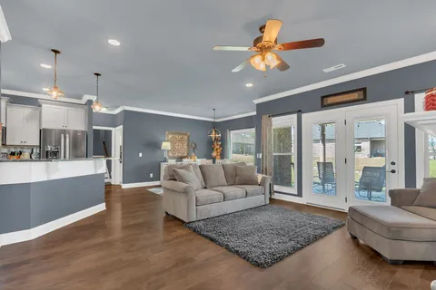 a living room with furniture and a chandelier