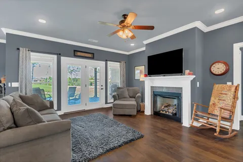 a living room with furniture a fireplace and a flat screen tv