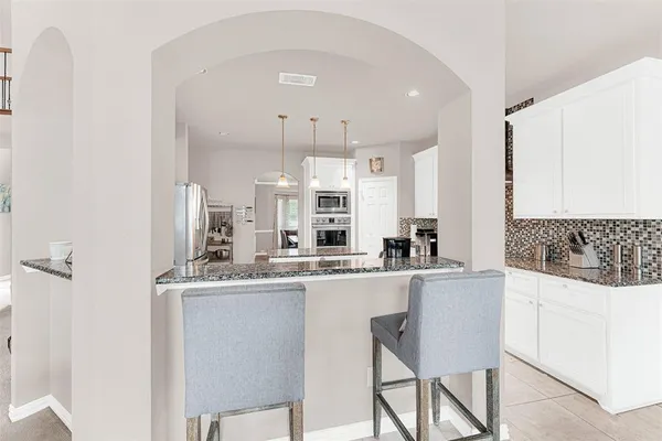a kitchen with stainless steel appliances a sink stove and cabinets