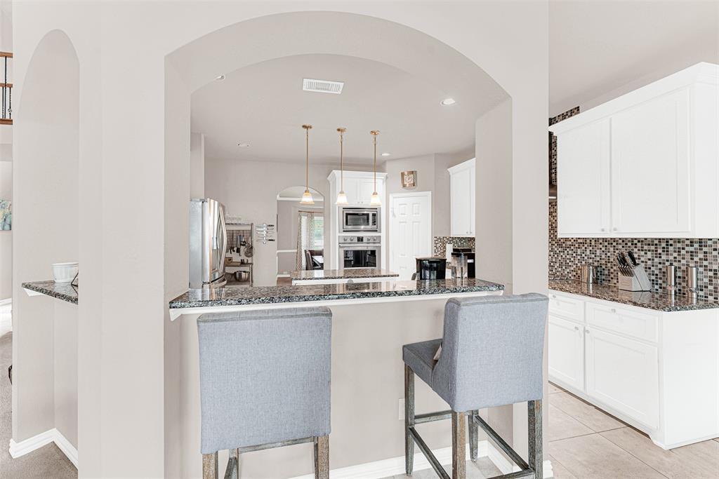 128 Chestnut Lane Red Oak, TX 75154 - Photo 11 of 28 a kitchen with stainless steel appliances a sink stove and cabinets