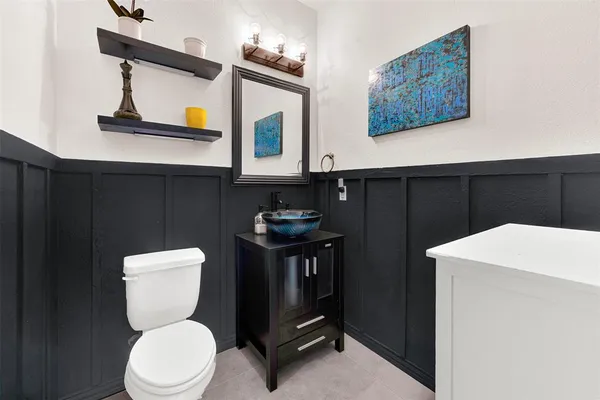 a bathroom with a toilet a sink and mirror