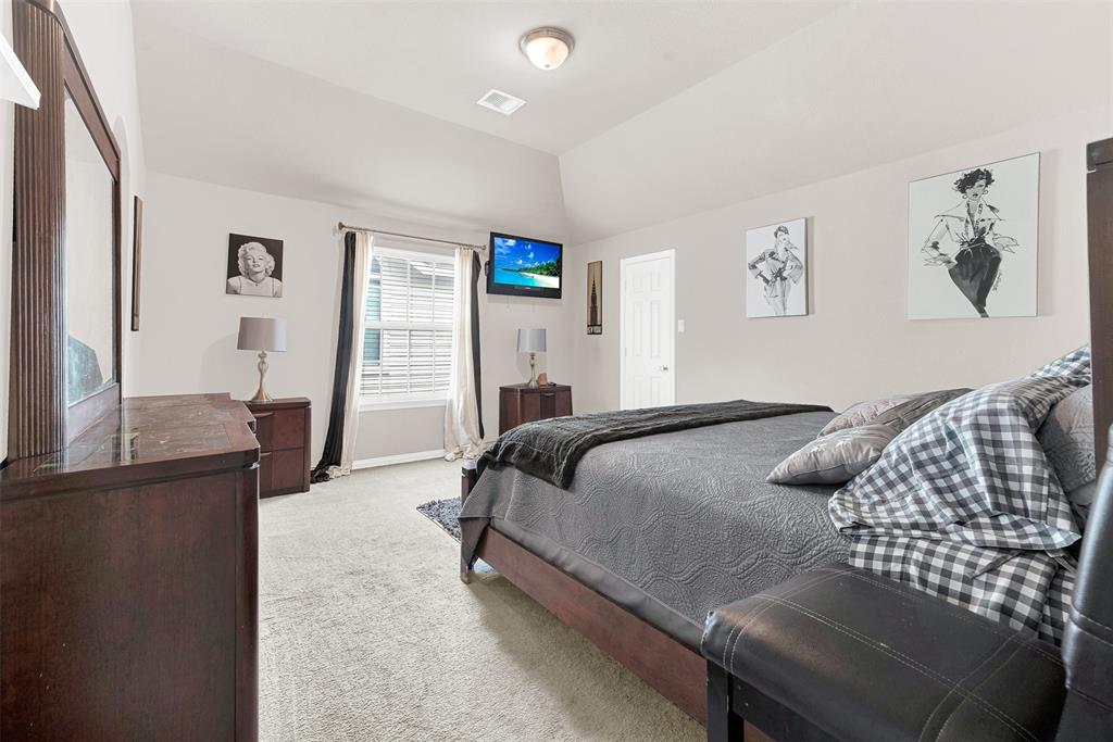 128 Chestnut Lane Red Oak, TX 75154 - Photo 21 of 28 a bedroom with a bed and wooden floor