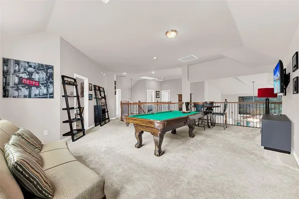 a room with furniture and pool table