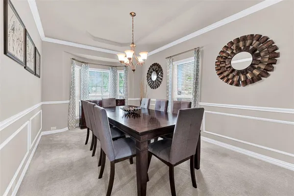 a view of a dining room and a table and chairs