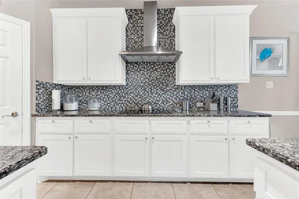 a kitchen with white cabinets