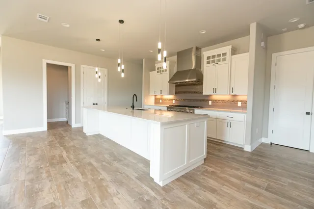 a view of kitchen with stainless steel appliances cabinets