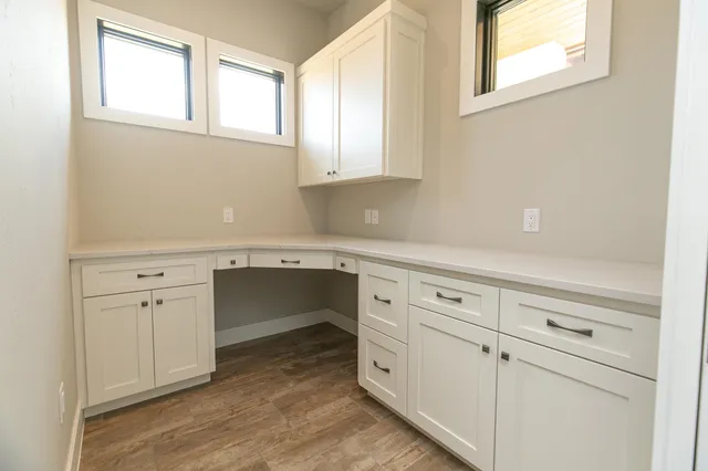 a kitchen with white cabinets and white appliances