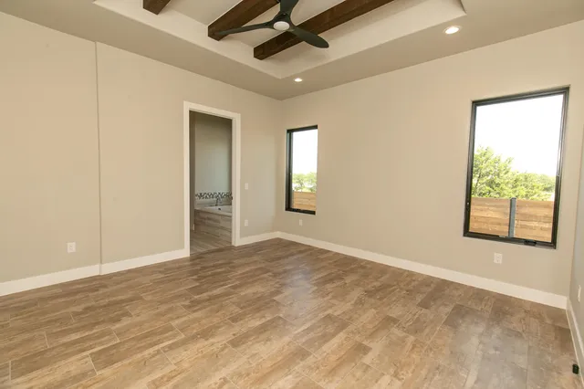 an empty room with windows and closet